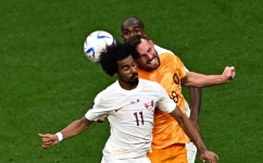 Qatar’s Akram Afif heads the ball against the Netherlands: AFP/Anne-Christine Poujoulat