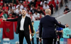 Morocco's coach Walid Regragui (left) gestures to his players from the touchline during their Qatar 2022 World Cup Group F match at the Al-Thumama Stadium in Doha on November 27, 2022. (Photo by JACK GUEZ / AFP)