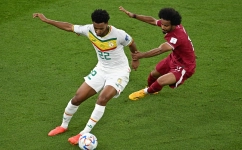 Senegal’s Abdou Diallo, left, and Qatar’s Akram Afif vie for the ball: AFP/Manan Vatsyayana