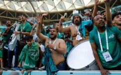 Supporters of Saui Arabia celebrate their team's victory during the Qatar 2022 World Cup Group C football match between Argentina and Saudi Arabia at the Lusail Stadium in Lusail, north of Doha on November 22, 2022. (Photo by Odd ANDERSEN / AFP)