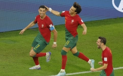 Portugal’s Cristiano Ronaldo, left, celebrates with team-mates Joao Felix, centre, and Bernardo Silva after scoring against Ghana: AFP/Odd Andersen