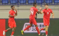 Canada's forward Lucas Cavallini (R) celebrates scoring with teammates during a friendly football match between Canada and Japan at Al-Maktoum Stadium in Dubai on November 17, 2022. (Photo by KARIM SAHIB / AFP)