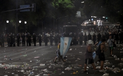 Riot police stand guard after clashes with fans of Argentina following the celebration of the team’s arrival in Buenos Aires: AFP/Luis Robayo