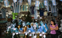 A woman walks inside a store in the eve of the Qatar 2022 World Cup final match between Argentina and France in Buenos Aires, on December 16, 2022. (Photo by Luis ROBAYO / AFP)