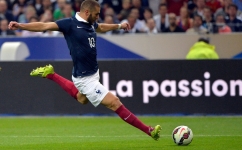 In this file photo taken on September 4, 2014, French forward Karim Benzema strikes during the friendly football match France vs Spain, at the Stade de France in Saint-Denis, north of Paris. (Photo by Miguel MEDINA / AFP)
