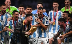 Argentina's Lionel Messi holds the World Cup trophy during the Qatar 2022 World Cup trophy ceremony at Lusail Stadium in Lusail on December 18, 2022. (Photo by FRANCK FIFE / AFP)