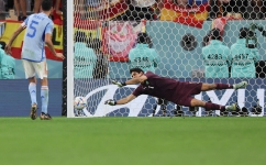 Morocco's goalkeeper Yassine Bounou saves a penalty from Spain's Sergio Busquets during the penalty shoot-out of their World Cup round of 16 match at the Education City Stadium in Al-Rayyan on December 6, 2022. (Photo by KARIM JAAFAR / AFP)