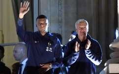 France's forward Kylian Mbappe (left) and coach Didier Deschamps greet supporters at the Hotel de Crillon, a day after the Qatar 2022 World Cup final match Place de la Concorde in central Paris on December 19, 2022. (Photo by JULIEN DE ROSA / AFP)