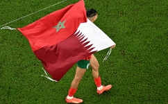 Morocco's defender Jawad El Yamiq celebrates winning the Qatar 2022 World Cup quarter-final match against Portugal at the Al-Thumama Stadium in Doha on December 10, 2022. (Photo by MANAN VATSYAYANA / AFP)