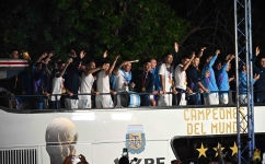 Argentina players celebrate on board a bus as they leave the Ezeiza International Airport: AFP/Luis Robayo