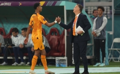 Netherlands coach Louis Van Gaal greets forward Cody Gakpo as he leaves the pitch during their Round of 16 match against USA: AFP/Adrian Dennis