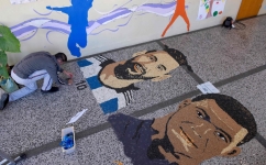 Kosovar artist Alkent Pozhegu works on the last details of his mosaic, made with grain and seeds, depicting Lionel Messi and Kylian Mbappe in Gjakova on December 17, 2022. (Photo by Armend NIMANI / AFP)
