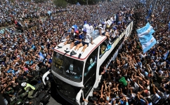 Fans of Argentina cheer as the team parades on board a bus in Buenos Aires: AFP/Luis Robayo
