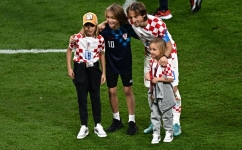 Luka Modric celebrates with his children Ema, Ivano and Sofia after winning the Qatar 2022 World Cup third place play-off match against Morocco at Khalifa International Stadium in Doha on December 17, 2022. (Photo by Anne-Christine POUJOULAT / AFP)