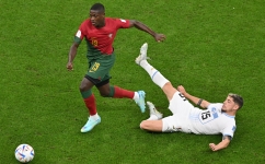 Portugal’s Nuno Mendes gets the ball past Uruguay’s Federico Valverde: AFP/Glyn Kirk