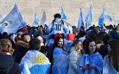 Fans wave Argentine flags as they celebrate their team's victory in the Qatar 2022 World Cup final football match against France, in Washington, DC, on December 18, 2022. (Photo by Daniel SLIM / AFP)