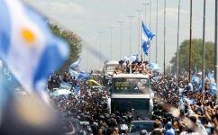 Fans of Argentina cheer as the team parades on board a bus after winning the Qatar 2022 World Cup tournament, in Buenos Aires province, on December 20, 2022.  (Photo by TOMAS CUESTA / AFP)