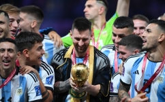 Lionel Messi looks at the World Cup trophy during the Qatar 2022 World Cup trophy ceremony after the final match against France at Lusail Stadium in Lusail on December 18, 2022. (Photo by FRANCK FIFE / AFP)