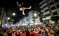 Morocco's supporters celebrate after their country's win of the Qatar 2022 World Cup match between Morocco and Portugal, in the capital Rabat, on December 10, 2022. (Photo by FADEL SENNA / AFP)