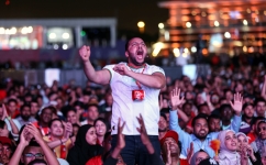 Morocco's supporters celebrate after their team won the Qatar 2022 World Cup round 16 match against Spain, at the FIFA fan zone in Doha, on December 6, 2022. (Photo by MAHMUD HAMS / AFP)