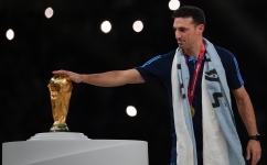 Argentina coach Lionel Scaloni touches the World Cup trophy at the Lusail Stadium on December 18: AFP/Franck Fife