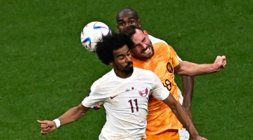 Qatar’s Akram Afif heads the ball against the Netherlands: AFP/Anne-Christine Poujoulat