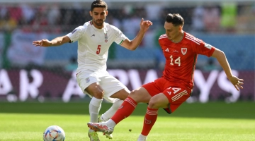 Iran’s Milad Mohammadi, left, and Wales’ Connor Roberts battle for the ball: AFP/Nicolas Tucat