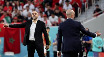 Morocco's coach Walid Regragui (left) gestures to his players from the touchline during their Qatar 2022 World Cup Group F match at the Al-Thumama Stadium in Doha on November 27, 2022. (Photo by JACK GUEZ / AFP)