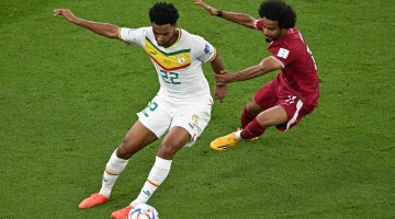 Senegal’s Abdou Diallo, left, and Qatar’s Akram Afif vie for the ball: AFP/Manan Vatsyayana
