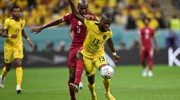 Ecuador's forward #13 Enner Valencia (right) fights for the ball with Qatar's defender #03 Karim Hassan Abdel during their match at the Al-Bayt Stadium on November 20, 2022. (Photo by MANAN VATSYAYANA / AFP)