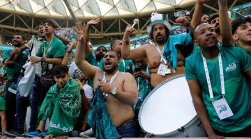 Supporters of Saui Arabia celebrate their team's victory during the Qatar 2022 World Cup Group C football match between Argentina and Saudi Arabia at the Lusail Stadium in Lusail, north of Doha on November 22, 2022. (Photo by Odd ANDERSEN / AFP)