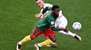 Cameroon’s Georges-Kevin Nkoudoul, left, fights for the ball with Serbia’s Filip Kostic: AFP/Anne-Christine Poujoulat