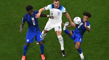 USA’s Yunus Musah, left, Tyler Adams fight for the ball with England’s Harry Kane: AFP/Manan Vatsyayana