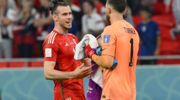 Wales' forward Gareth Bale (left) greets USA's goalkeeper Matt Turner at the end of their Qatar 2022 World Cup Group B at the Ahmad Bin Ali Stadium in Al-Rayyan on November 21, 2022. (Photo by NICOLAS TUCAT / AFP)