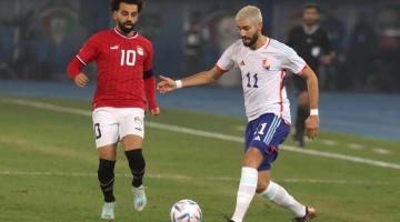Egypt's forward Mohamed Salah (L) and Belgium's midfielder Yannick Carrasco vie for the ball during the friendly football match between Belgium and Egypt at the Jaber Al-Ahmad Stadium in Kuwait City on November 18, 2022. (Photo by Yasser Al-Zayyat / AFP)