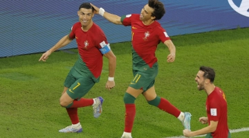Portugal’s Cristiano Ronaldo, left, celebrates with team-mates Joao Felix, centre, and Bernardo Silva after scoring against Ghana: AFP/Odd Andersen