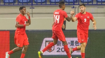 Canada's forward Lucas Cavallini (R) celebrates scoring with teammates during a friendly football match between Canada and Japan at Al-Maktoum Stadium in Dubai on November 17, 2022. (Photo by KARIM SAHIB / AFP)