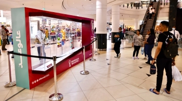 Visitors look at one of the mascots on display at the City Center Mall in Doha.