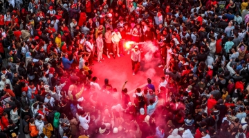 Morocco's supporters celebrate after their country's win of the Qatar 2022 World Cup match against Portugal, in Rabat, on December 10, 2022. (Photo by FADEL SENNA / AFP)