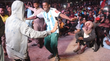 Fans dance as they watch the live broadcast of semifinal between Argentina and Croatia in the Lyari neighbourhood of Karachi: AFP/Rizwan Tabassum