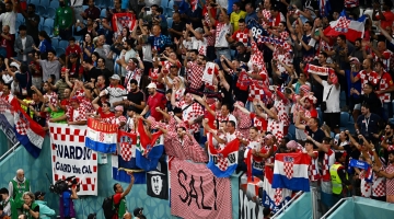 Croatia supporters celebrate after their team won the Qatar 2022 World Cup round of 16 match against Japan at the Al-Janoub Stadium in Al-Wakrah, south of Doha on December 5, 2022. (Photo by Anne-Christine POUJOULAT / AFP)