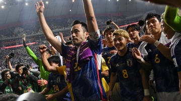 Japan's Maya Yoshida (center) and teammates celebrate with supporters at the end of the Qatar 2022 World Cup Group E match against Spain at the Khalifa International Stadium in Doha on December 1, 2022. (Photo by Philip FONG / AFP)