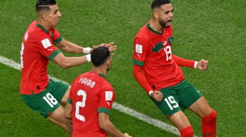Morocco's forward Youssef En-Nesyri celebrates scoring his team's goal during the Qatar 2022 World Cup quarter-final match against Portugal at the Al-Thumama Stadium in Doha on December 10, 2022. (Photo by NELSON ALMEIDA / AFP)