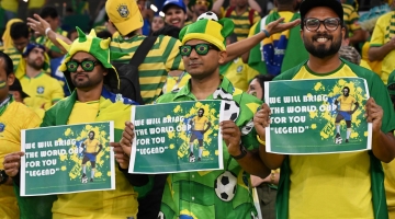 Brazil supporters pose with signs for Pele prior to the Qatar 2022 quarter-final match between Croatia and Brazil at Education City Stadium in Al-Rayyan on December 9, 2022. (Photo by NELSON ALMEIDA / AFP)