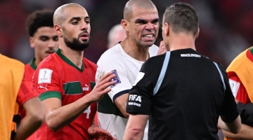 Portugal's Pepe (centre) argues with referee Facundo Tello during the Qatar 2022 World Cup quarter-final match against Morocco at the Al-Thumama Stadium in Doha on December 10, 2022. (Photo by Kirill KUDRYAVTSEV / AFP)