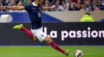 In this file photo taken on September 4, 2014, French forward Karim Benzema strikes during the friendly football match France vs Spain, at the Stade de France in Saint-Denis, north of Paris. (Photo by Miguel MEDINA / AFP)