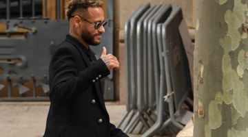 In this file photo taken on October 17, 2022, PSG Brazilian forward Neymar gestures as he leaves leaves after attending the opening audience at the courthouse in Barcelona, on the first day of his trial.  (Photo by Pau BARRENA / AFP)