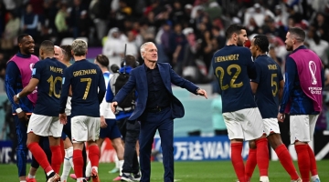 France's coach Didier Deschamps (centre) celebrates with his players after they won the Qatar 2022 World Cup quarter-final match against England at the Al-Bayt Stadium in Al Khor  on December 10, 2022. (Photo by Anne-Christine POUJOULAT / AFP)