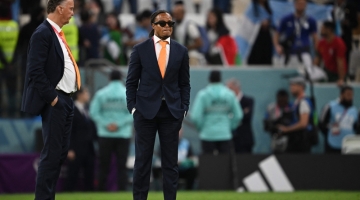 Netherlands' coach Louis Van Gaal and assistant coach Edgar Davids (right) react to their team's defeat in the Qatar 2022 World Cup quarter-final match against Argentina at Lusail Stadium, Qatar, on December 9, 2022. (Photo by Paul ELLIS / AFP)