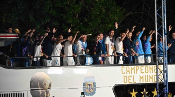 Argentina players celebrate on board a bus as they leave the Ezeiza International Airport: AFP/Luis Robayo